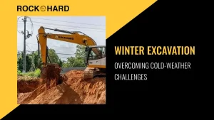 Winter excavation site with heavy machinery breaking frozen ground
